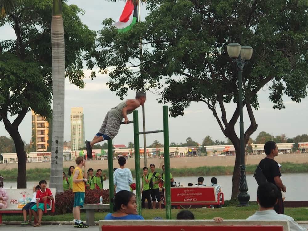 A man using outdoor exercise equipment in Phnom Penh
