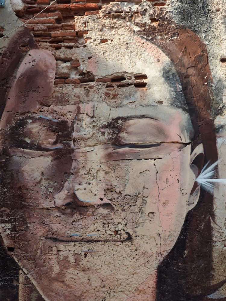 Getsemani street art - face with eyes shut