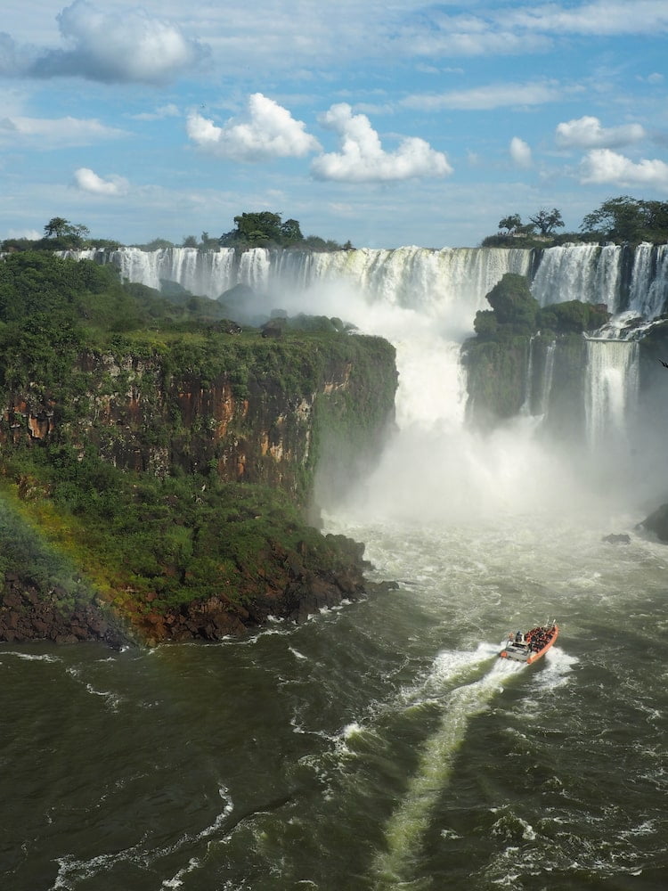 A speedboat with tourists approaches San Martin Fall