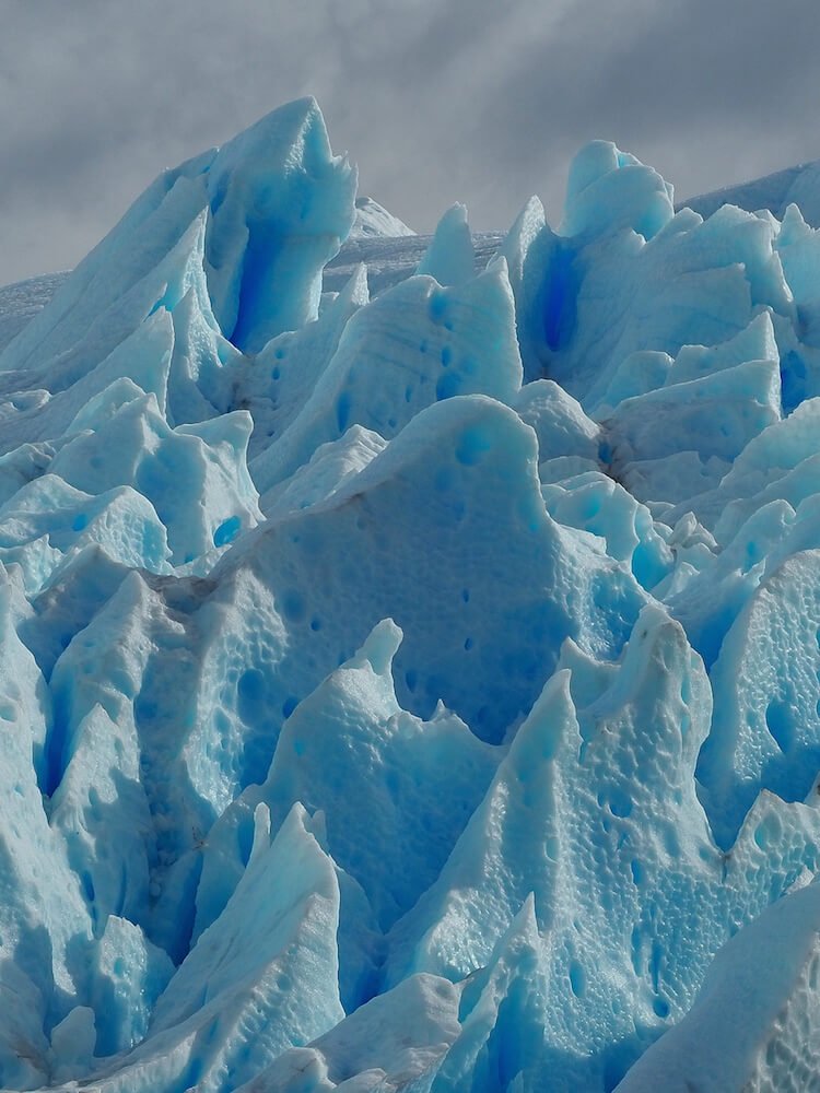 Honeycombed blue-tinged ice on the glacier walk