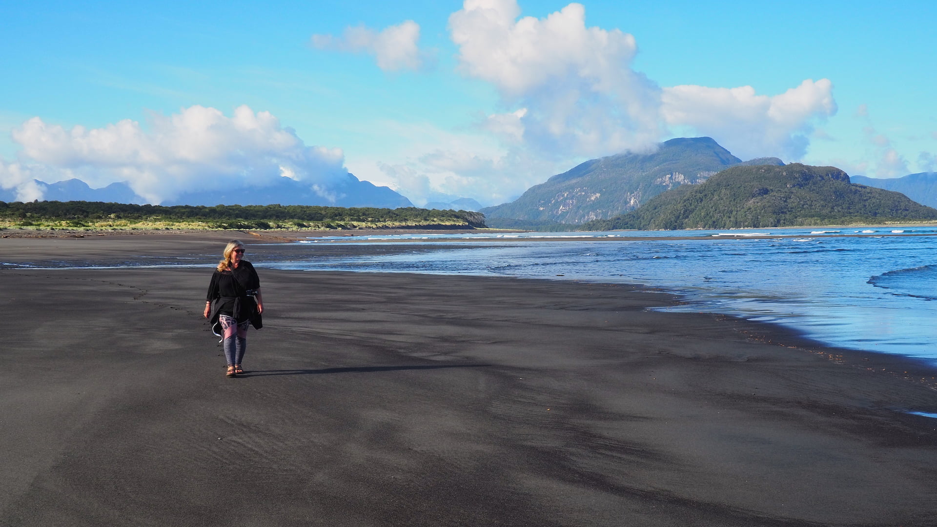 Nicky walking ocean side of the beach