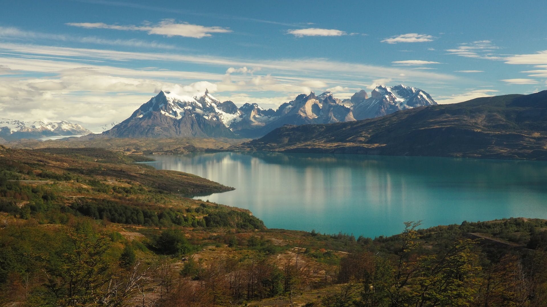 Lake in the foreground, jagged mountain peaks in the background