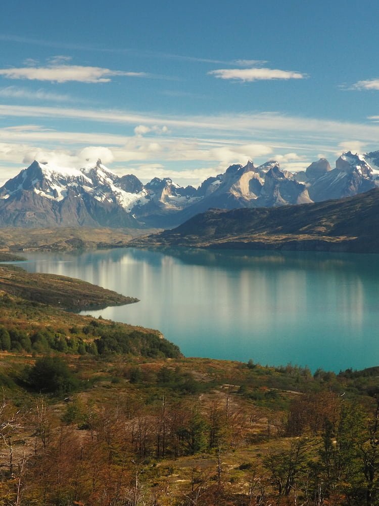 Lake in the foreground, jagged mountain peaks in the background