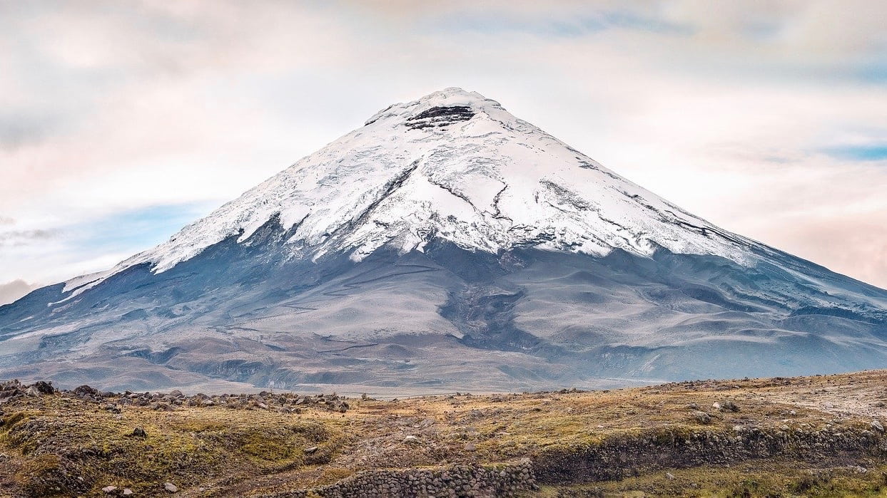 Conical-shaped volcano covered in snow