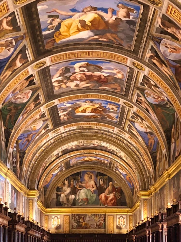 A curved and panelled ceiling with multiple religious frescoes