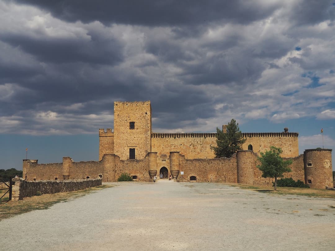 A castle with a stormy sky in the background