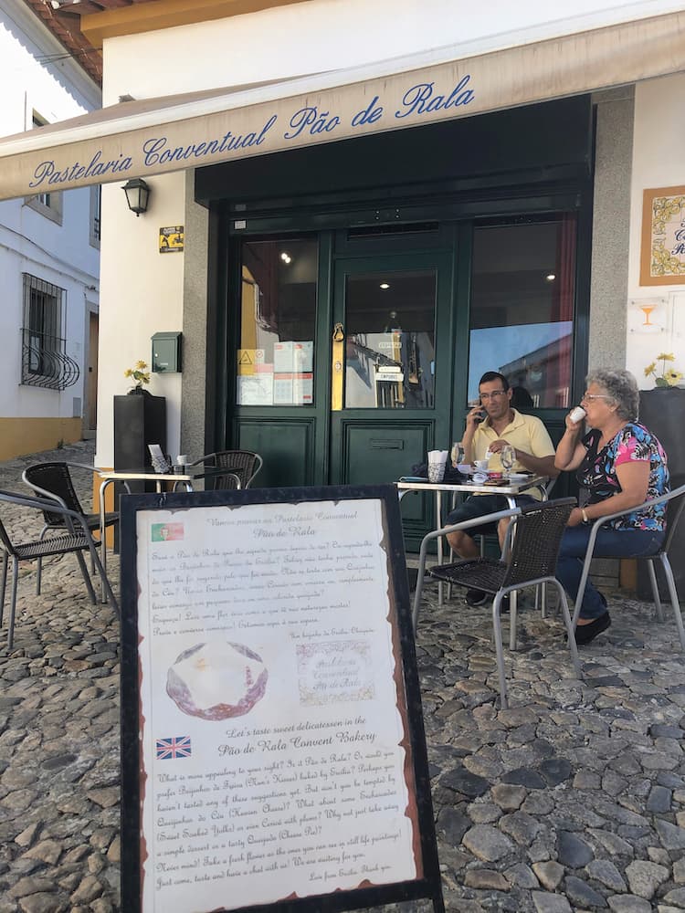 2 people sitting outside a cafe