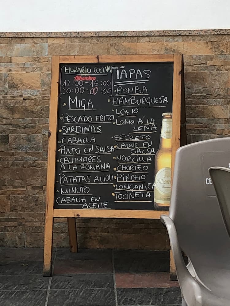A blackboard with a food menu written in white chalk