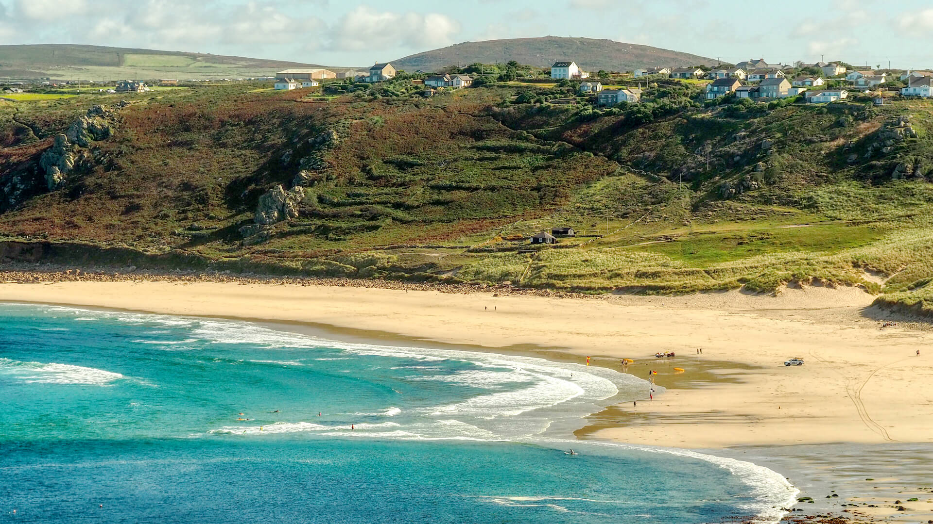 The remains of a shipwreck lies on a beach between two cliffs