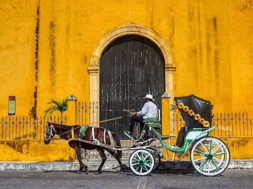 Horse and cart in front of yellow church, Izamal, Mexico