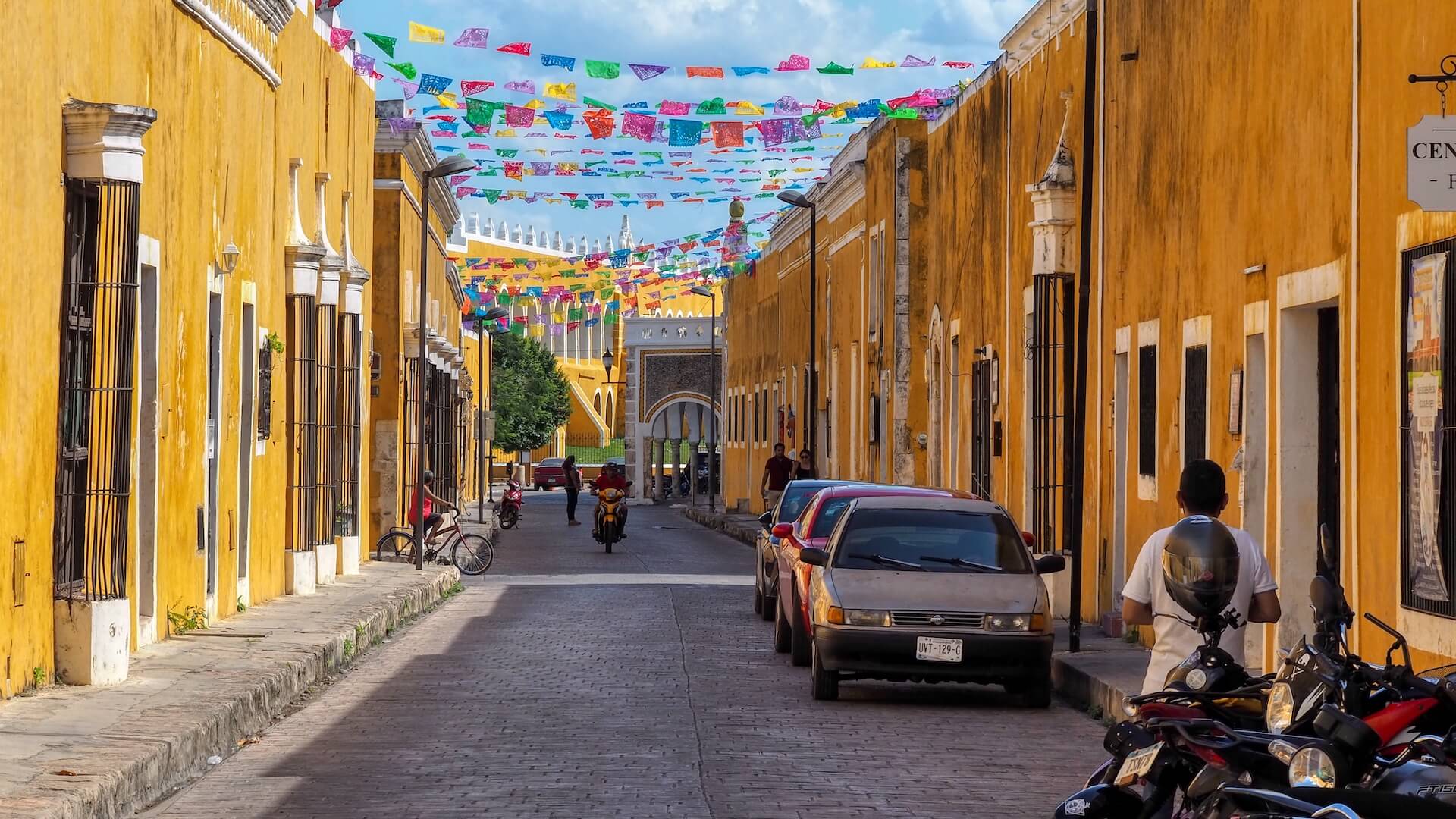 A street scene in Izamal showing its iconic yellow buildings on either side