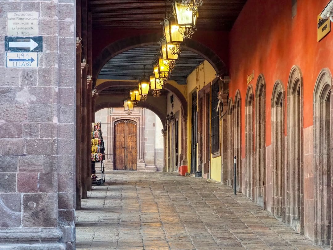 Arched arcade with row of lamps hanging from ceiling