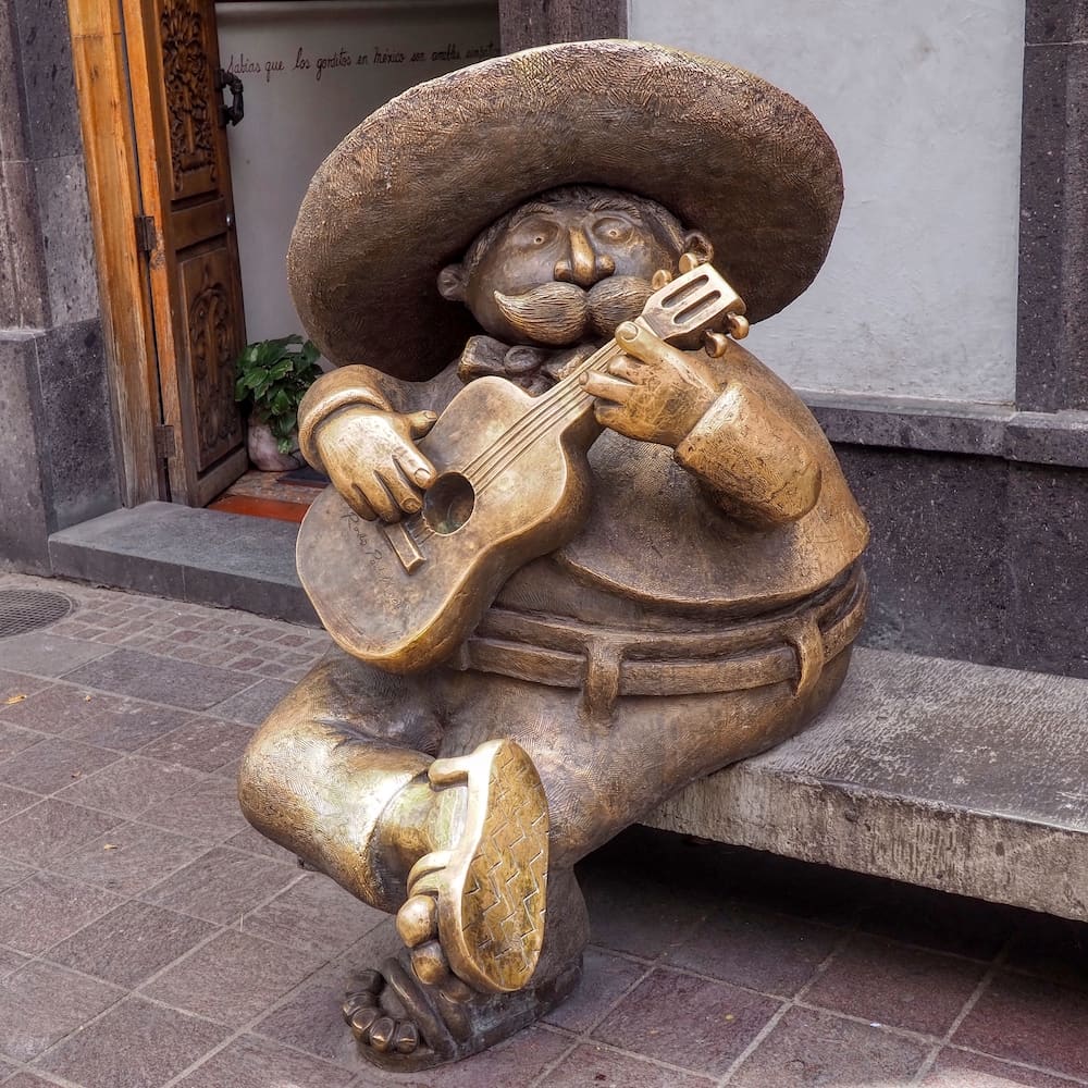 Sculpture of mariachi musician playing a guitar