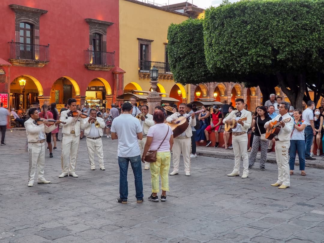 Mariachi band playing in front of a couple of people
