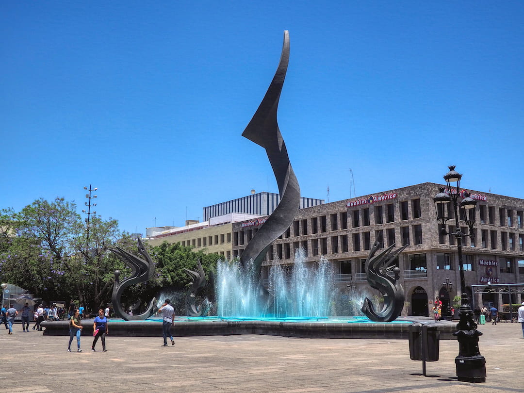 A fountain and twisting sculpture on Plaza Tapatia
