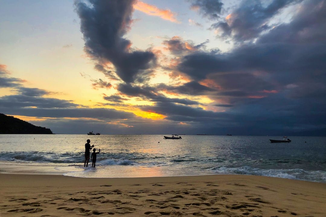 People fishing at sunset on Aracatiba Beach
