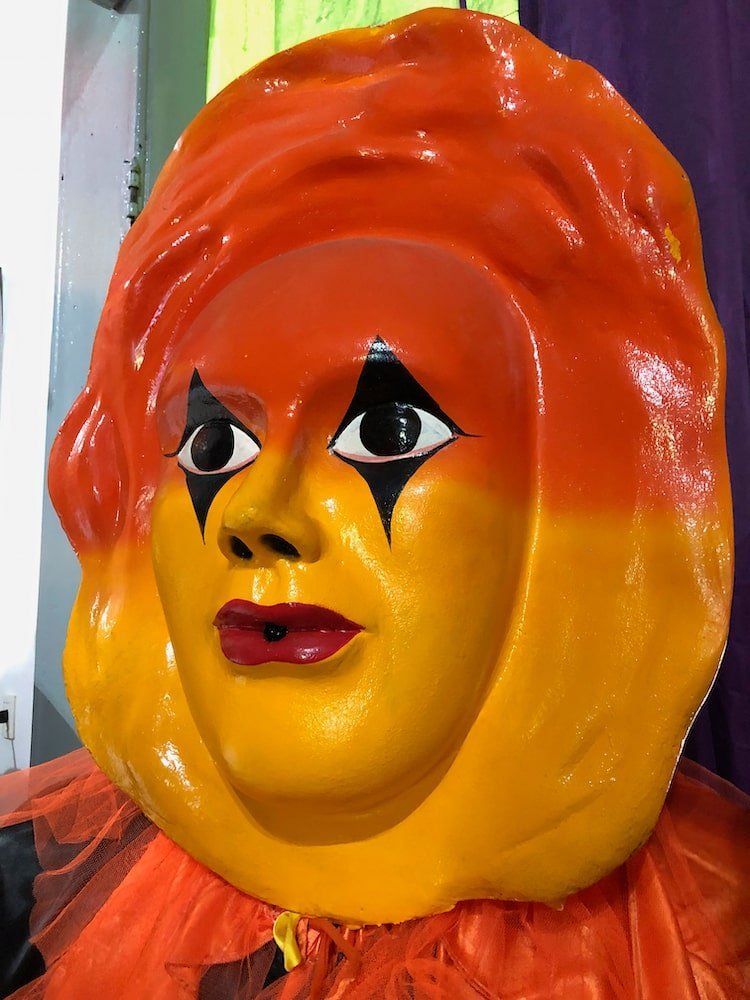 Orange and yellow puppet face in Olinda