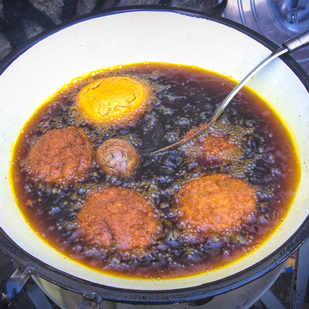 Acarajé patties frying in dênde oil