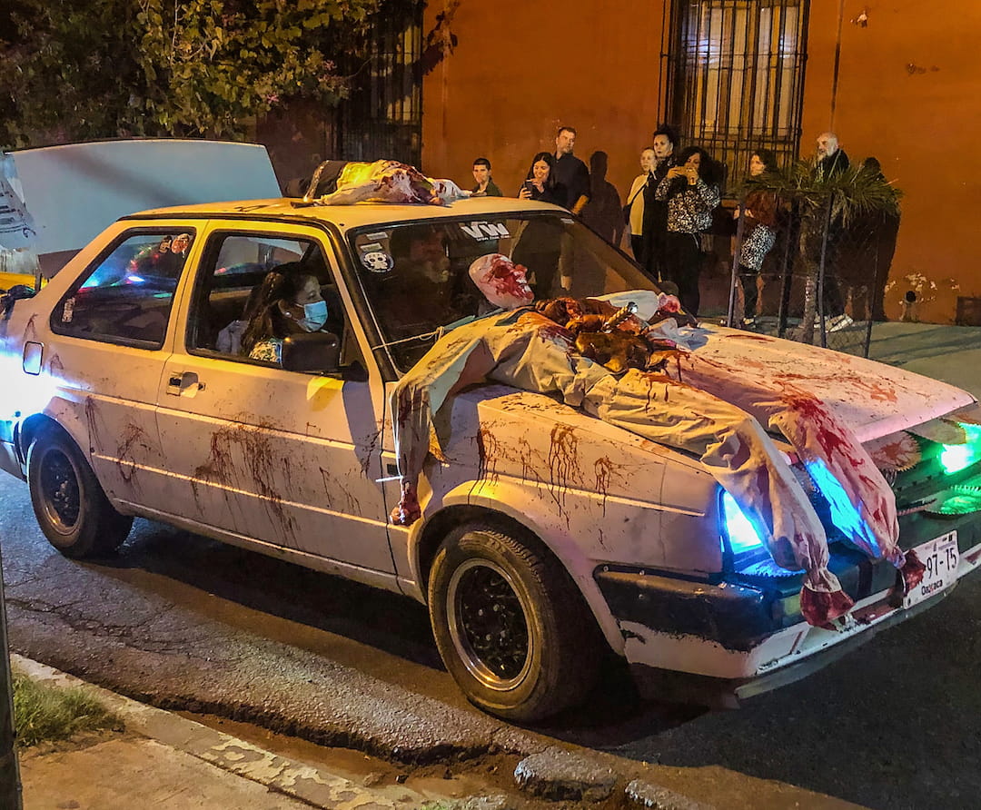 A white car is "decorated" with a gruesome looking dummy on its bonnet