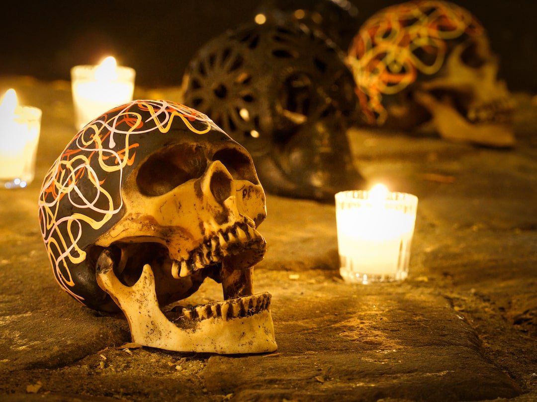 Oaxaca Day of the Dead - lit candles and skulls in a public display