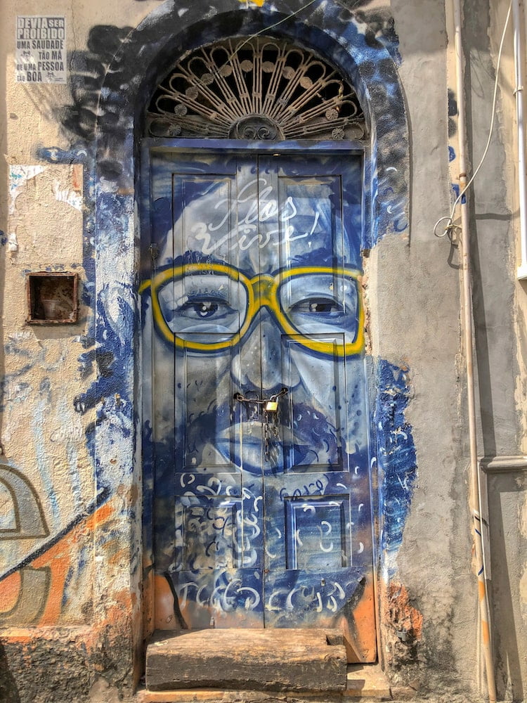 Street art of blue man with yellow glasses